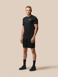 Full body model wearing black Adapt Training Shorts with matching top for an athletic workout look