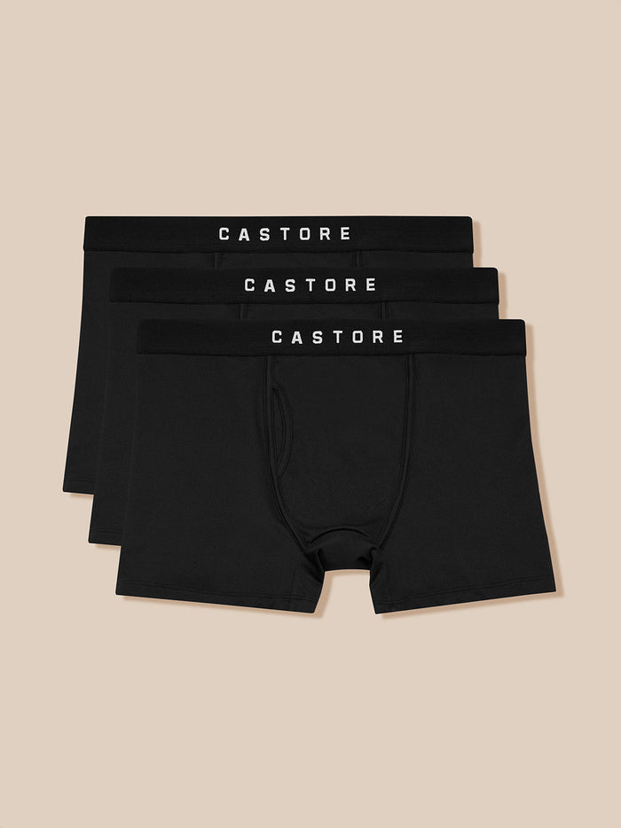 Three black Castore boxer shorts with elastic waistbands stacked together.