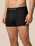 Front view of a male model wearing black Castore boxer shorts with a logo waistband