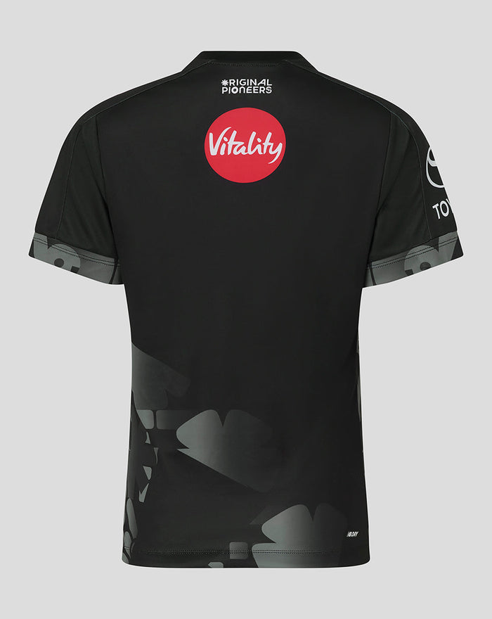 Back view of black Manchester Originals women's replica shirt with a red Vitality sponsor circle
