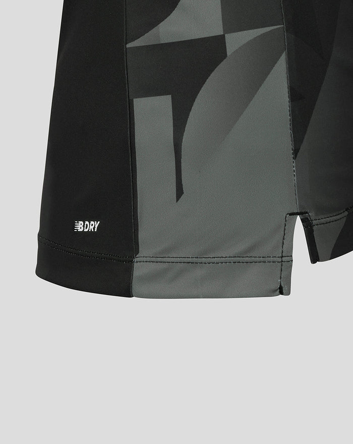 Hem detail of black Manchester Originals shirt with NB DRY logo and gray camouflage panels