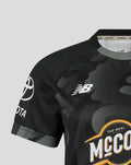 Close up of a black camouflage Manchester Originals replica shirt with the NB logo and sponsor emblem.