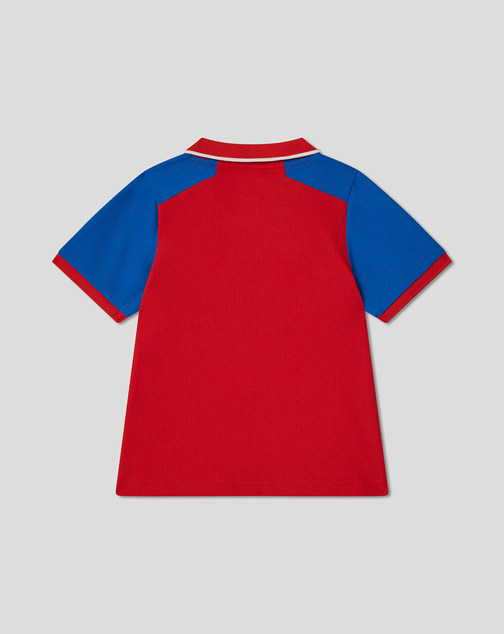 Back view of infant red T20 cricket shirt with blue sleeves