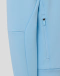 Close-up of light blue Travel Flex hoodie fabric with a vertical zip pocket detail