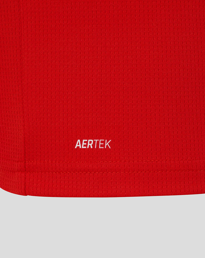 Close-up of red fabric texture with AERTEK label at the hem