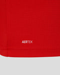 Close-up of red fabric texture with AERTEK label at the hem