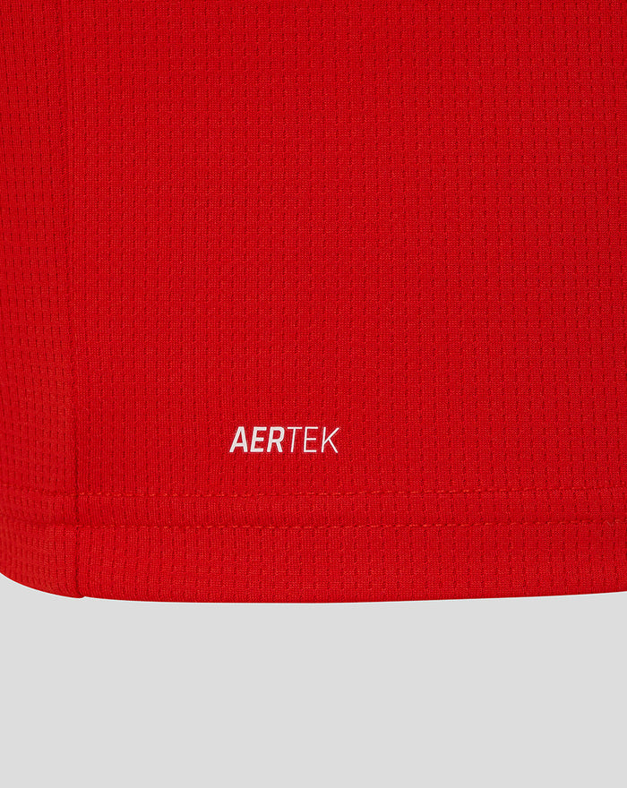 Close-up of red fabric texture with AERTEK label at the hem