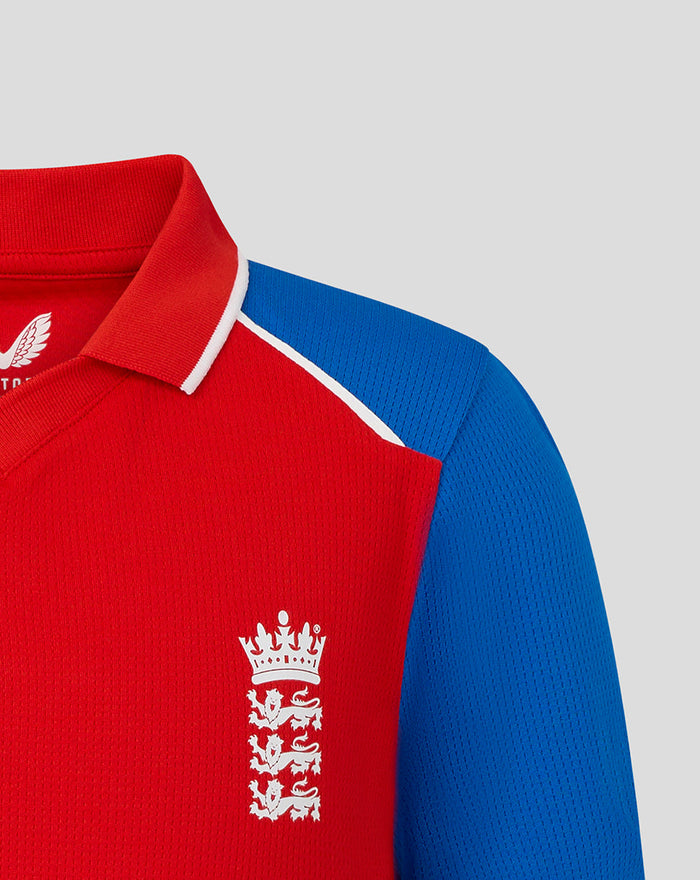 Close up of red junior T20 shirt with blue shoulder panel white collar trim and England crest on the chest.
