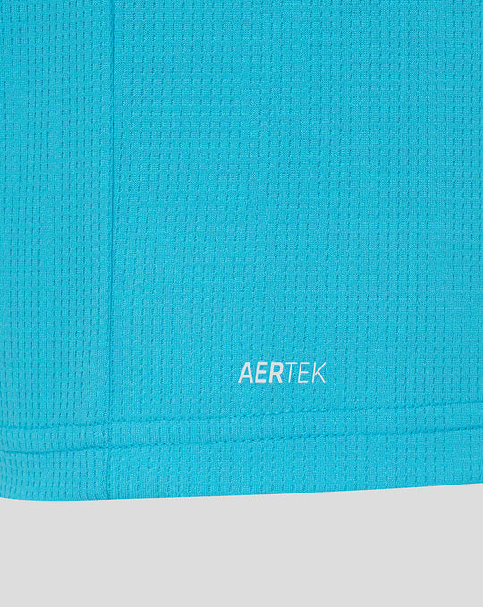 Close up of bright blue fabric near the hem showing AERTEK branding.