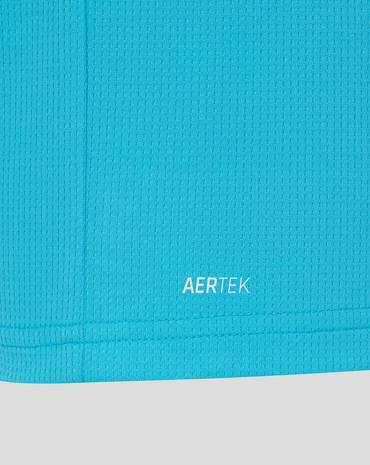 Close up of bright blue fabric near the hem showing AERTEK branding.