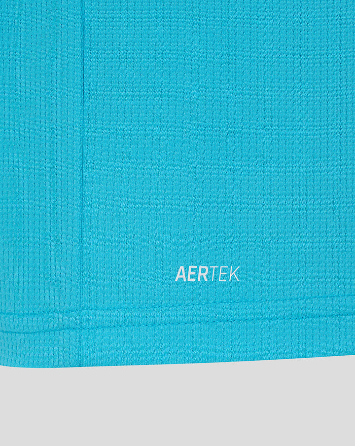 Close up of bright blue fabric near the hem showing AERTEK branding.