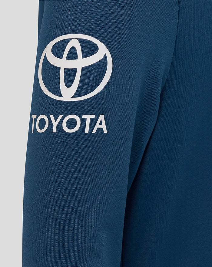 Close-up of sleeve showing bold Toyota logo on blue midlayer fabric.