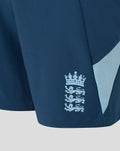 Close-up of blue junior shorts showing the Three Lions crest near the hem.