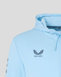 Close-up of light blue hoodie chest displaying Castore logo.
