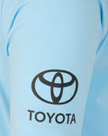 Close up of light blue polo sleeve showing the Toyota logo
