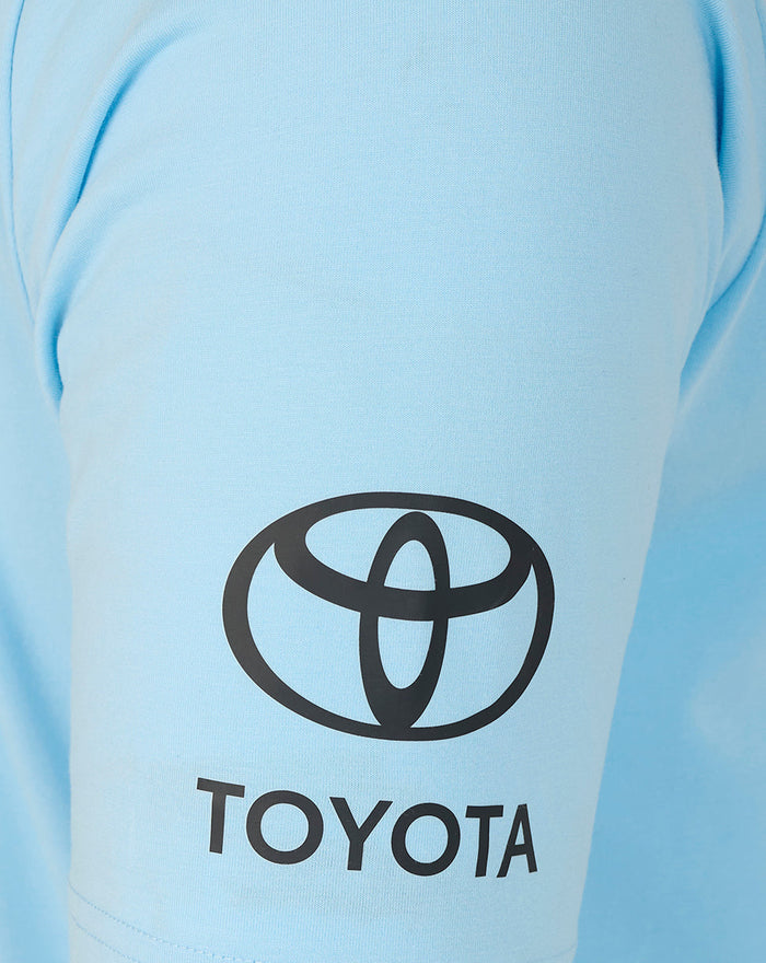Close up of light blue polo sleeve showing the Toyota logo