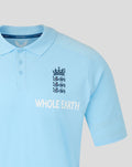 Light blue Travel Polo close up showing England crest and Whole Earth branding on chest.