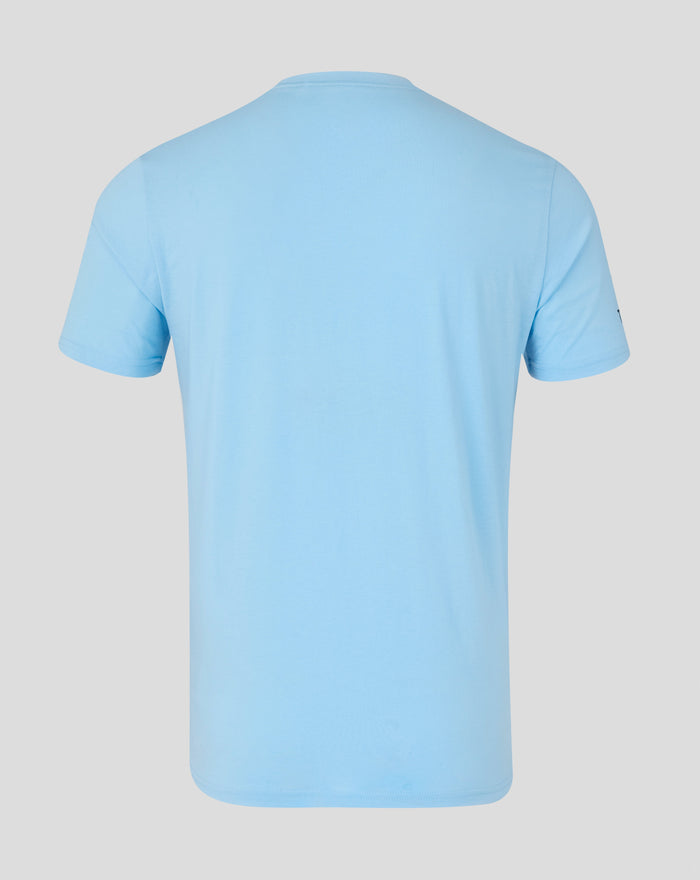 Front view of light blue Travel T-Shirt with navy crest on chest and WHOLE EARTH slogan