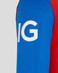 Close up of blue sleeve with bold white logo and red trim on the T20 Pro shirt