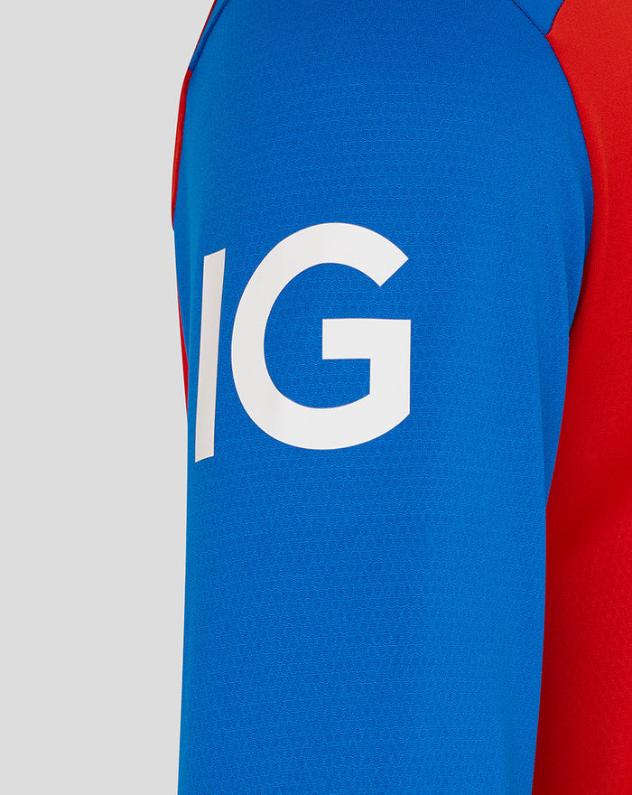 Close up of blue sleeve with bold white logo and red trim on the T20 Pro shirt