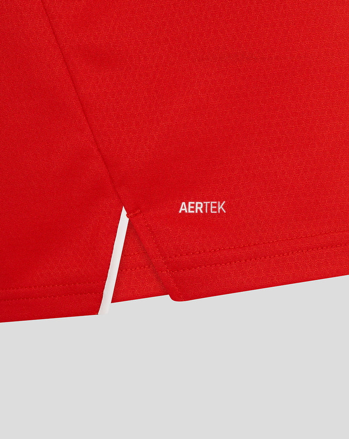 Close up of red T20 Pro long sleeve shirt fabric with AERTEK logo near the hem
