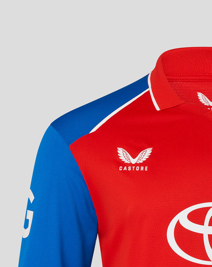 Red T20 Pro long sleeve cricket shirt with blue shoulder panel and Castore branding on chest.
