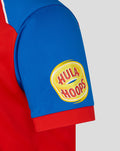 Close-up of blue sleeve with a yellow circular Hula Hoops patch on a red T20 Pro shirt.