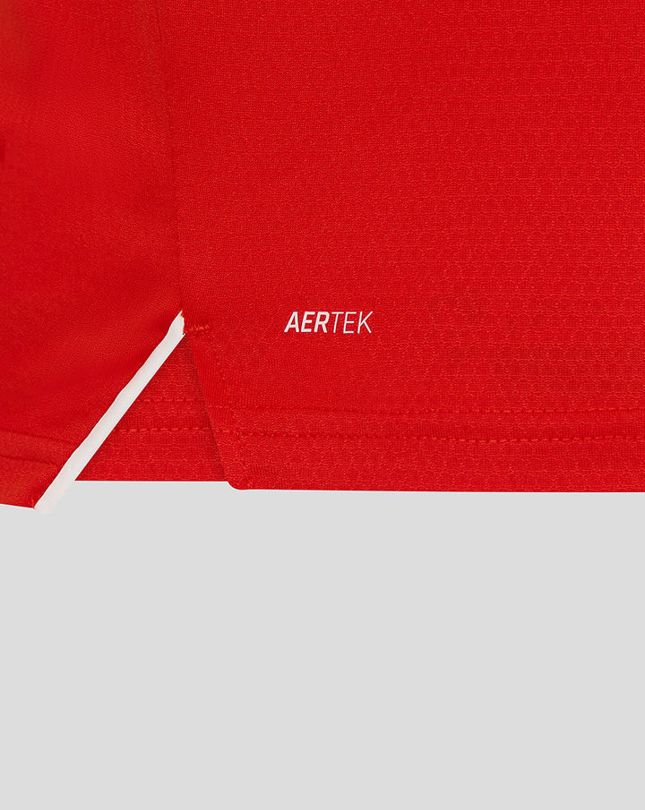 Close-up of red fabric featuring the AERTEK branding on the T20 Pro shirt.