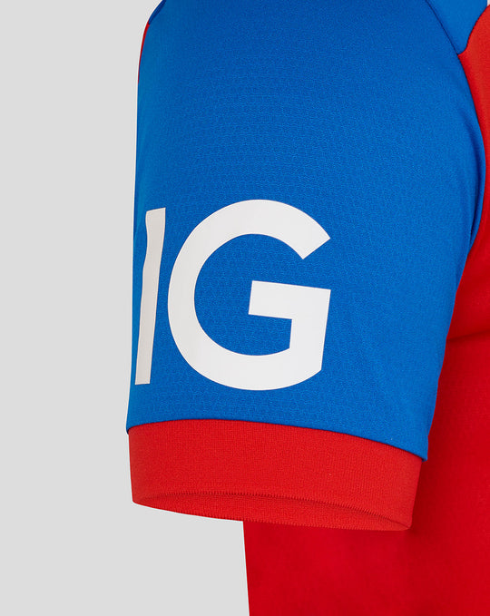 Close-up of a blue sleeve with a red cuff from the T20 Pro cricket shirt, featuring large white lettering.