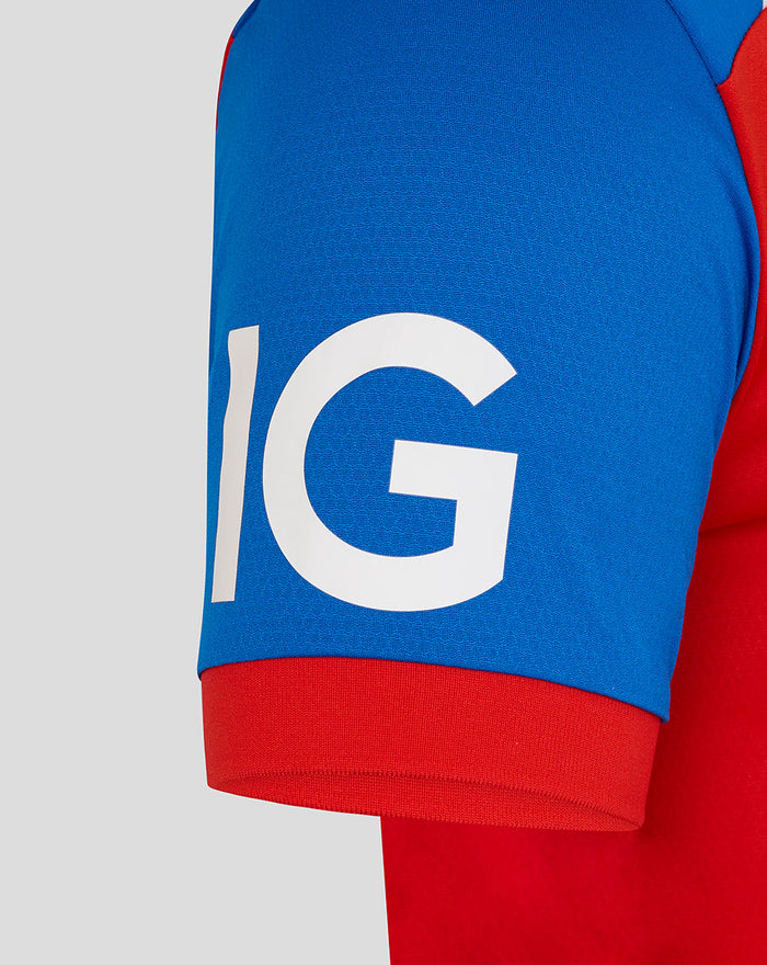 Close-up of a blue sleeve with a red cuff from the T20 Pro cricket shirt, featuring large white lettering.