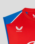 Close-up of red vest chest showing the Castore logo with wing emblem