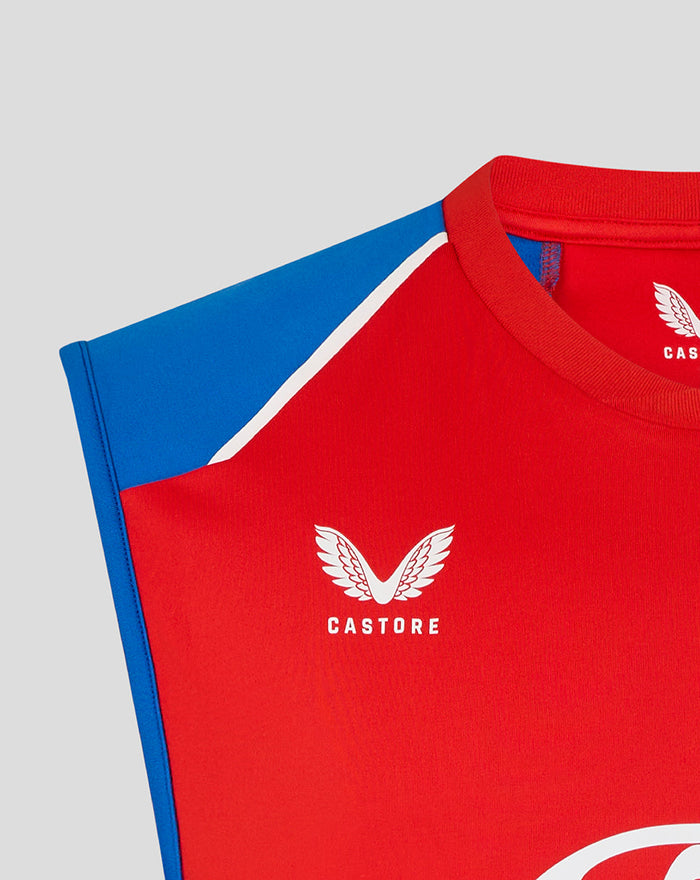 Close-up of red vest chest showing the Castore logo with wing emblem