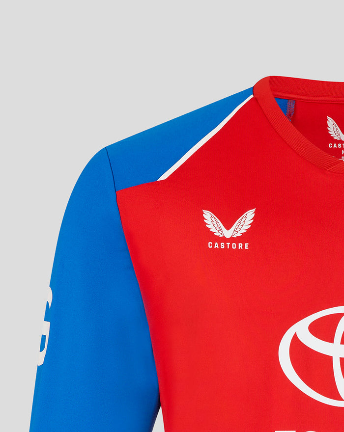 Close up of red T20 sweater showing a blue shoulder panel, white shoulder stripe, and Castore branding near the neck