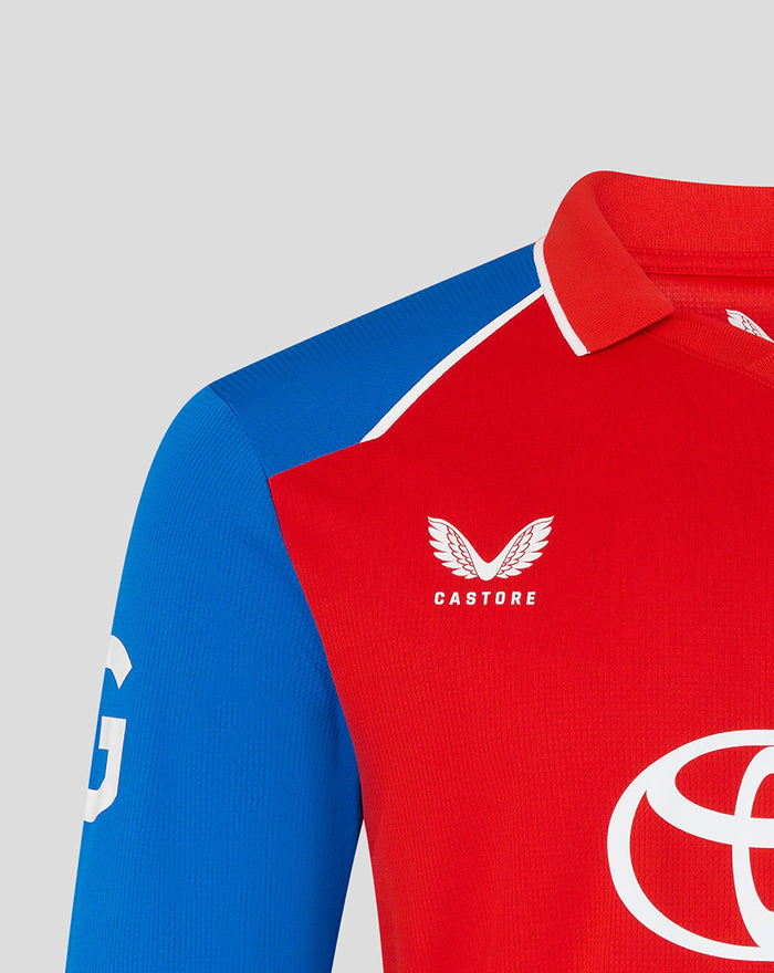 Red chest with Castore logo and winged emblem on the T20 cricket shirt, blue sleeve visible