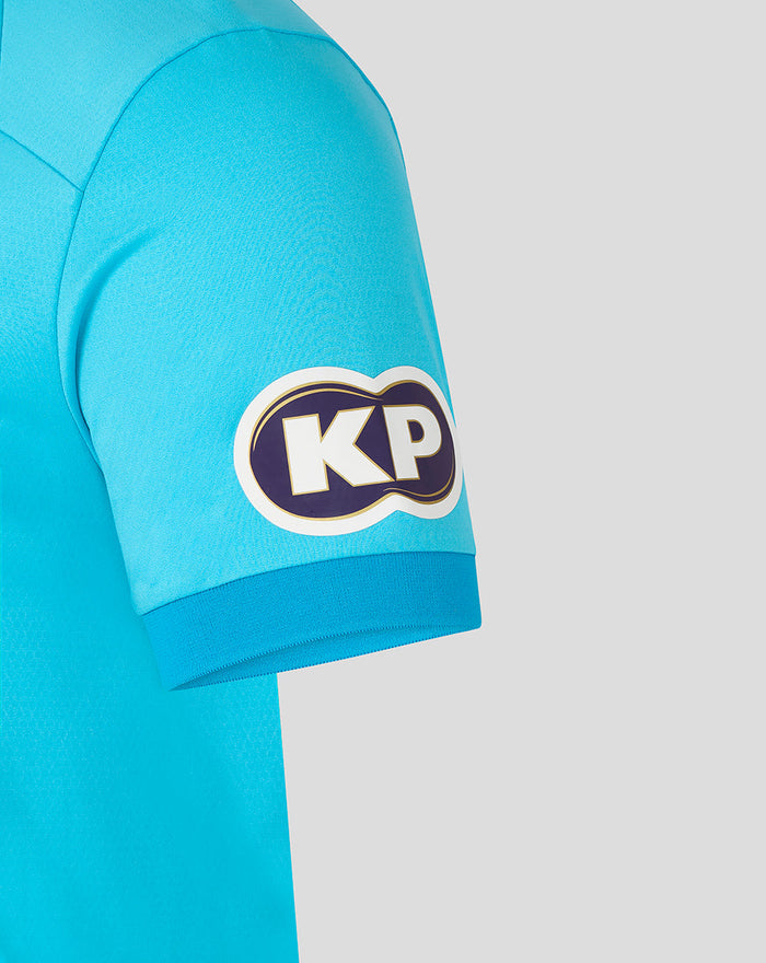Close-up of sleeve patch KP in purple and gold on turquoise ODI Pro shirt.