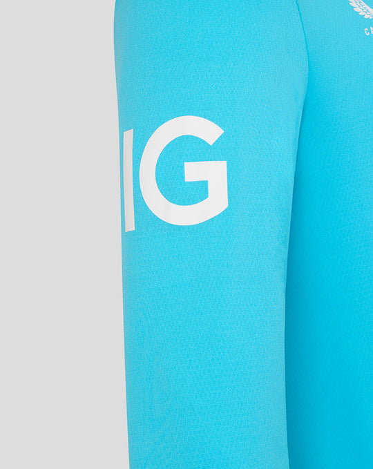 Close-up of bright blue sleeve with bold white letters on fabric.
