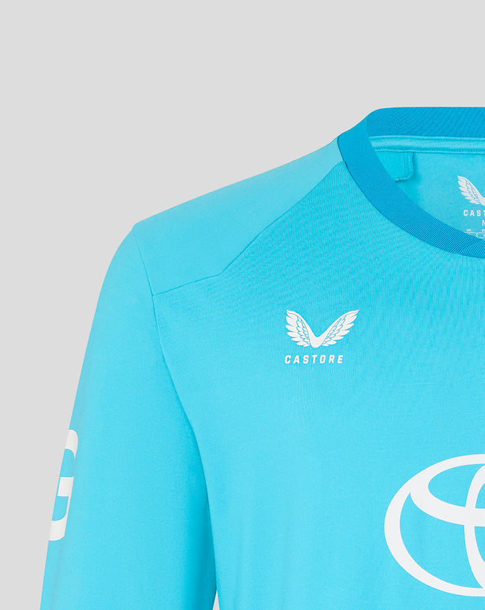 Front view of blue ODI sweater with Castore logo and a large white circular emblem on the chest