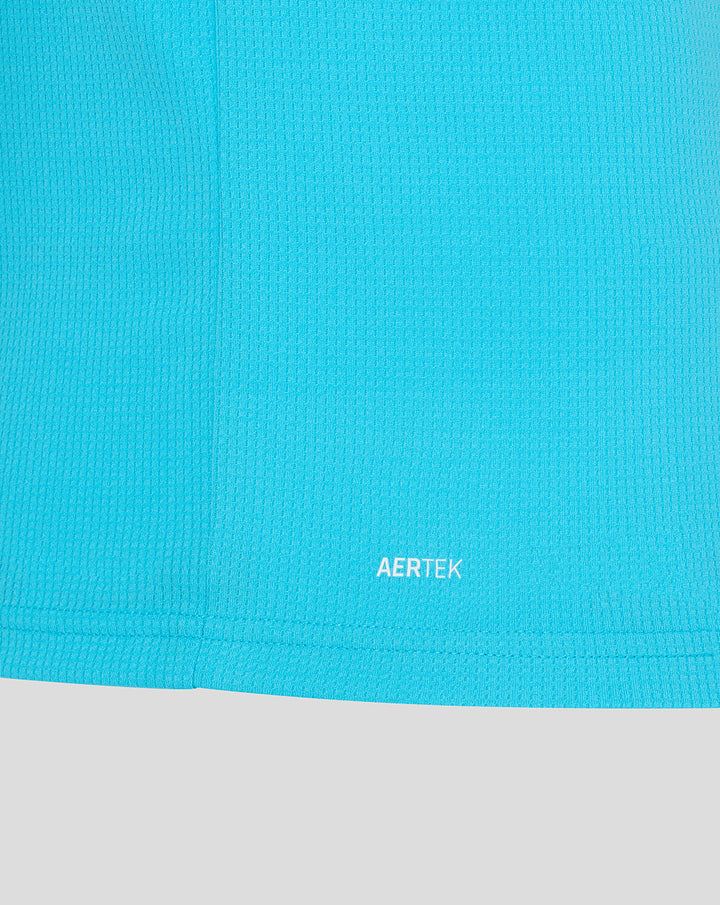 Close-up of bright blue ODI short sleeve shirt fabric with AERTEK branding at the hem