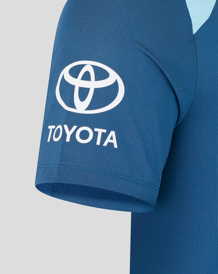Blue training short sleeve shirt fabric close-up with a white Toyota emblem on the chest