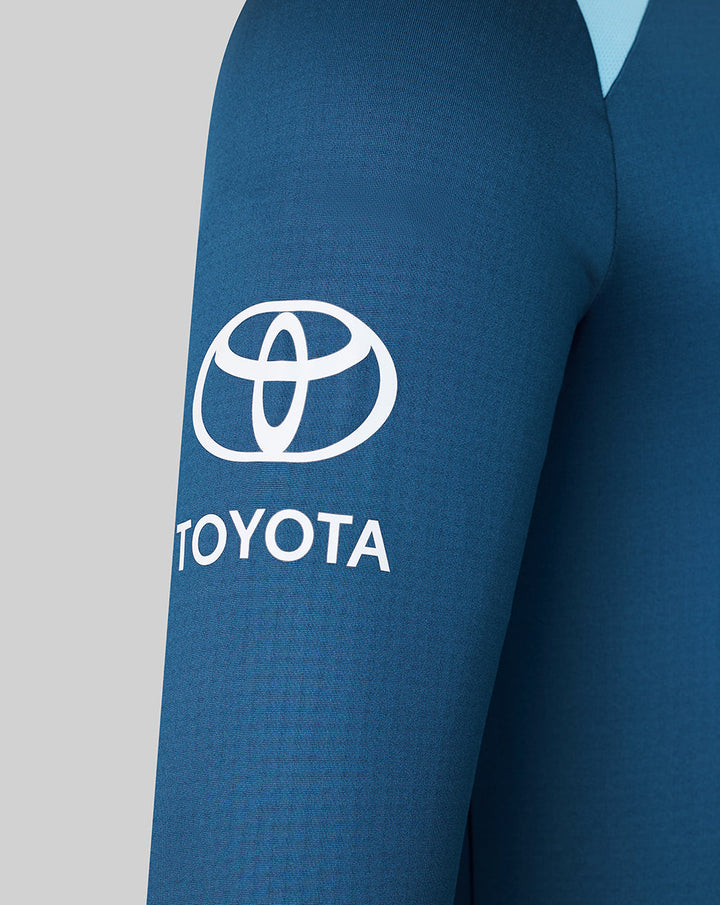 Blue training midlayer sleeve with white Toyota logo.