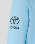 Toyota logo and branding printed on the lower back of a light blue hoodie