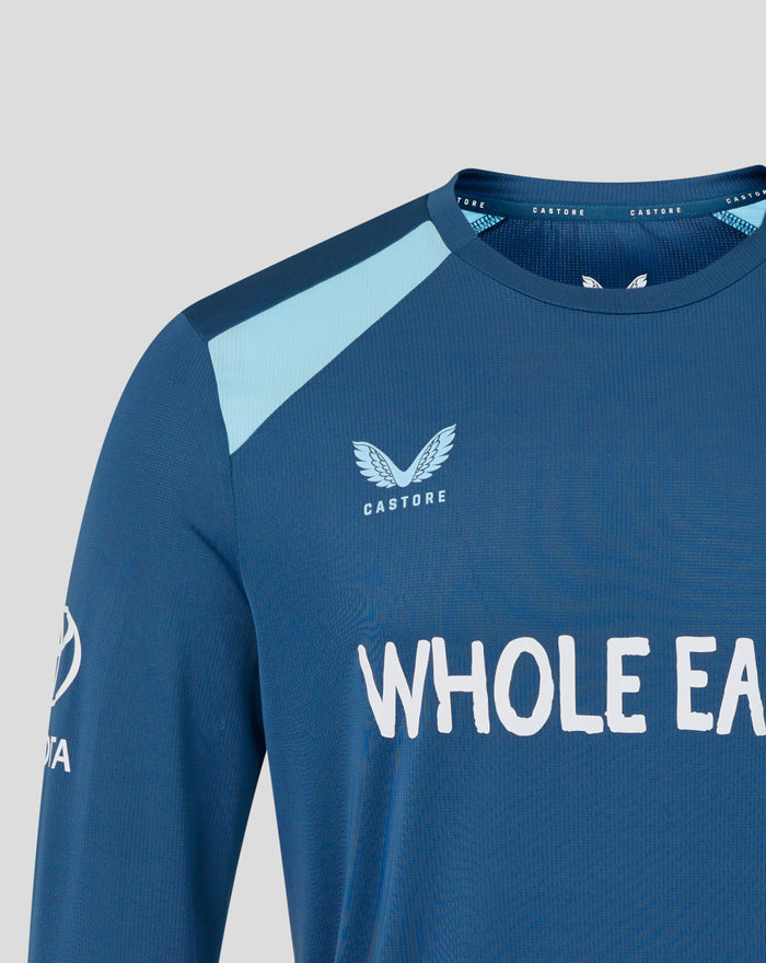 Neckline close up of blue training shirt with CASTORE branding along the collar and a white wing emblem on the chest