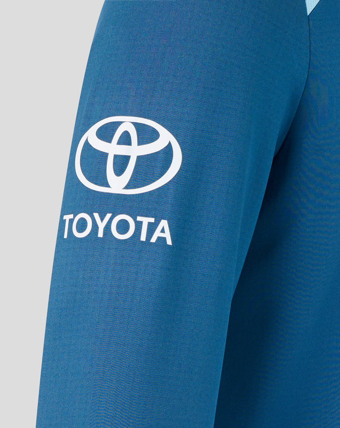 Blue training sweatshirt close-up with a large white Toyota logo on the front.