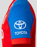 Close-up of blue sleeve with white Toyota logo on a red England cricket jersey.