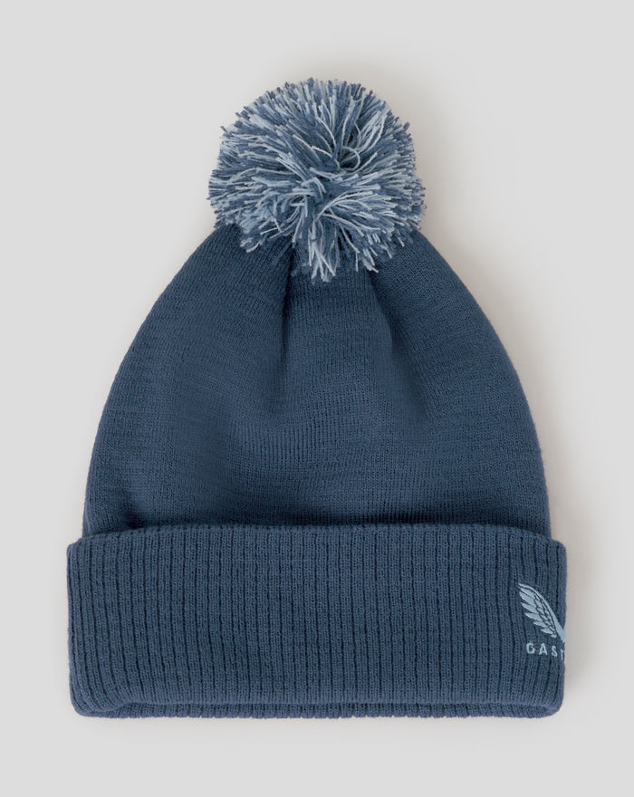 Blue bobble hat close-up showing ribbed cuff and embroidered Three Lions crest