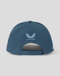 Back view of blue six panel training cap with white winged crest and Castore branding