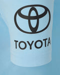 Close up of light blue polo fabric with large black Toyota logo across chest