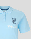 Close up of a light blue travel polo collar with inside Castore label and crest visible