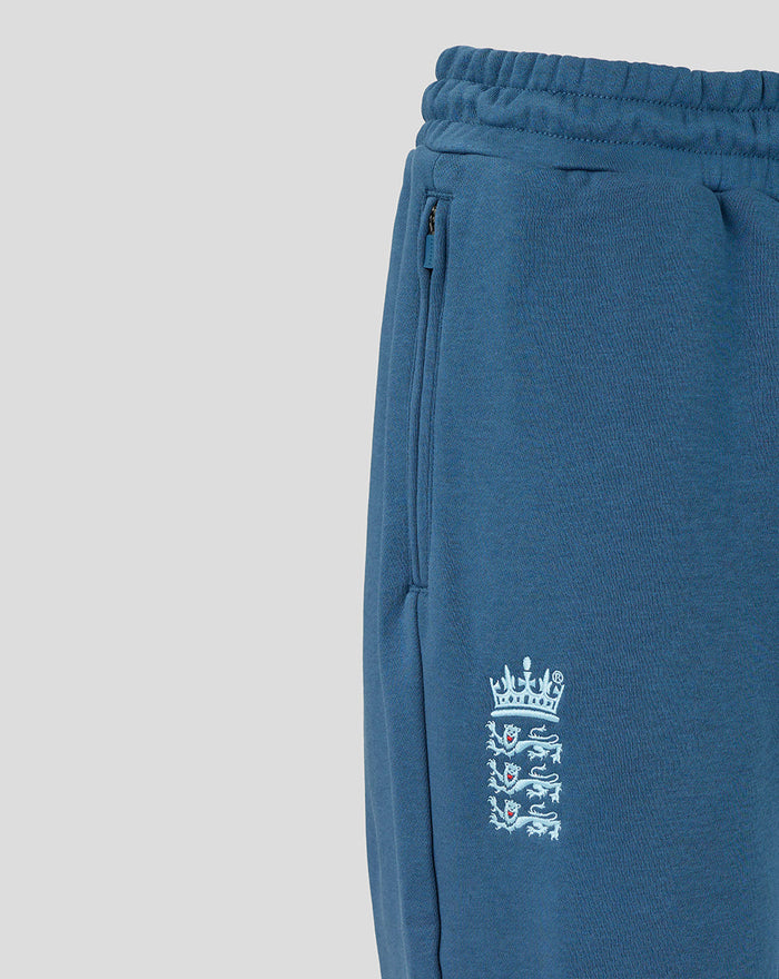 Ensign blue Travel Adapt fleece joggers close-up showing side zip pocket and Three Lions crest on the leg