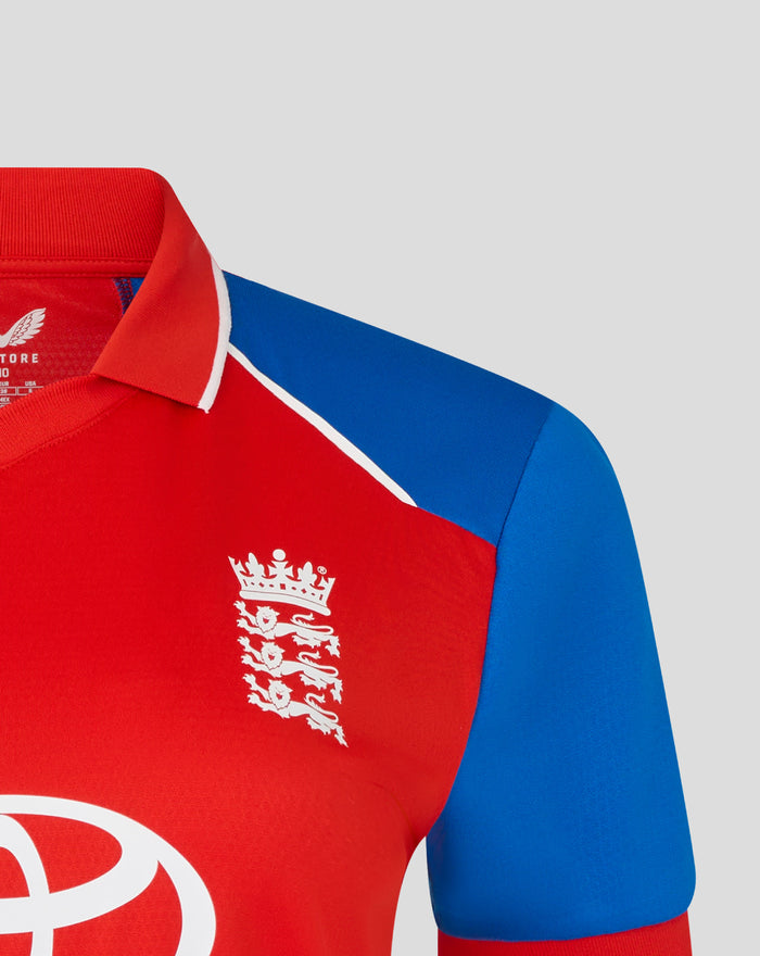 Red shirt chest displays a white crest and CASTORE branding with a blue sleeve nearby